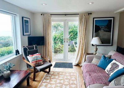 Seating area with french windows to small terrace garden