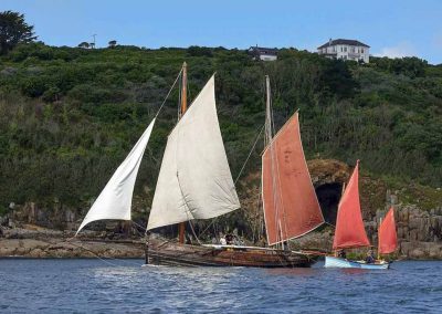 Boats with the Mousehole Cave below Carn Du House and Cottage